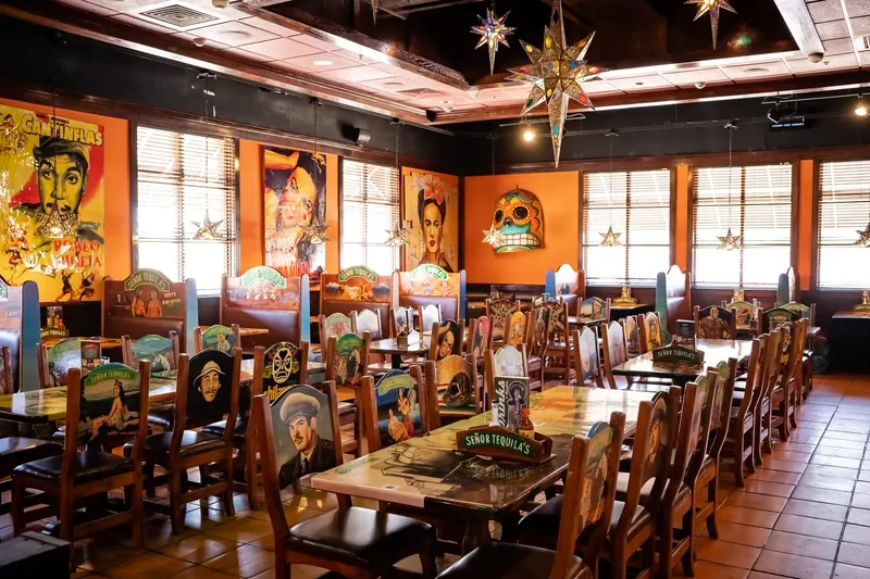 The Mexican Room set for dinner: long tables, painted wooden chairs and a star lantern